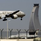 An Etihad Airways plan prepares to land at the Abu Dhabi airport, in United Arab Emirates, Sunday, May 4, 2014. Etihad Airways, a fast-growing Mideast carrier, laid out plans Sunday to offer passengers who find first-class seats a bit too tight a miniature suite featuring a closed-off bedroom, private bathroom and a dedicated butler. (AP Photo/Kamran Jebreili)